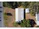 Aerial view of house with metal roof and surrounding landscaping at 11642 Martell Ct, Leesburg, FL 34788