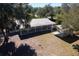 Aerial view of home with detached garage and large, covered patio at 11642 Martell Ct, Leesburg, FL 34788