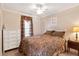 Bedroom featuring a bed, dresser, and window with curtains at 11642 Martell Ct, Leesburg, FL 34788