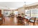 Dining and living room with hardwood floors offer views into the outside sunroom at 11642 Martell Ct, Leesburg, FL 34788