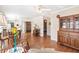 Spacious living room with hardwood floors offers views into the dining and living spaces at 11642 Martell Ct, Leesburg, FL 34788