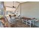 Screened porch with cushioned chairs, a table, and a ceiling fan at 11642 Martell Ct, Leesburg, FL 34788