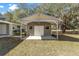 Detached shed with a covered area for storage, enhancing curb appeal and providing outdoor space at 11642 Martell Ct, Leesburg, FL 34788