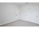 Bedroom featuring neutral carpeting, white walls and trim, and closet with sliding doors at 1193 Stratton Ave, Groveland, FL 34736