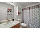 Bathroom showcasing a single sink vanity with granite countertop and cabinet storage at 11945 Se 91St Cir, Summerfield, FL 34491