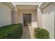 Close up of front door and entry way that features mature landscaping and hardscape leading to entrance at 11945 Se 91St Cir, Summerfield, FL 34491