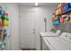 Bright laundry room with shelving and a white washer and dryer at 11945 Se 91St Cir, Summerfield, FL 34491