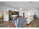 Living room with open floor plan that features hardwood flooring, neutral colors, and entertainment center at 11945 Se 91St Cir, Summerfield, FL 34491