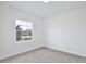 Neutral bedroom featuring a double-hung window at 1197 Stratton Ave, Groveland, FL 34736