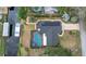 Stunning aerial view of home featuring a private pool, dock, and solar panels at 12338 S Putney Ct, Leesburg, FL 34788