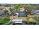 Aerial view of the property showcases the pool, boat dock, and the home's beautiful setting at 12338 S Putney Ct, Leesburg, FL 34788