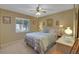 Bedroom with a ceiling fan, window with blinds, and neutral wall colors at 12338 S Putney Ct, Leesburg, FL 34788