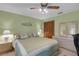 Bedroom with a ceiling fan, green walls, and closet at 12338 S Putney Ct, Leesburg, FL 34788