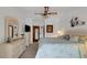 Serene bedroom with neutral walls, carpeted floor, ceiling fan, and a dresser at 12338 S Putney Ct, Leesburg, FL 34788