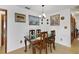 Dining room with decorative wood table and chairs, and decorative wall paintings at 12338 S Putney Ct, Leesburg, FL 34788