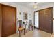 Welcoming entryway with glass table, two chairs, mirror and neutral tile flooring at 12338 S Putney Ct, Leesburg, FL 34788