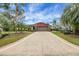 Beautiful exterior home elevation with a stone facade and a meticulously maintained front yard at 12338 S Putney Ct, Leesburg, FL 34788