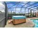 Screened in hot tub next to pool at 12338 S Putney Ct, Leesburg, FL 34788