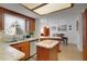 A bright kitchen featuring wood cabinetry, neutral countertops, and modern appliances at 12338 S Putney Ct, Leesburg, FL 34788