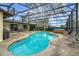 Large screened pool with deck and furniture at 12338 S Putney Ct, Leesburg, FL 34788