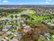 Aerial view of the community shows the home's proximity to a golf course and lake at 1415 Bethune Way, The Villages, FL 32162