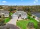 An aerial view of a well-maintained home nestled in a neighborhood with mature trees and green spaces at 1415 Bethune Way, The Villages, FL 32162