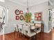 Bright dining room featuring hardwood floors, stylish mirrors, and modern light fixture at 1415 Bethune Way, The Villages, FL 32162