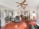 Open floor plan living room with ceiling fan, hardwood floors, and natural light at 1415 Bethune Way, The Villages, FL 32162