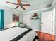 Comfortable main bedroom featuring a ceiling fan, wood floors, and closet at 1415 Bethune Way, The Villages, FL 32162