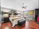 Inviting main bedroom with neutral tones, plantation shutters, dark wood furniture and hardwood flooring at 1415 Bethune Way, The Villages, FL 32162