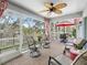 Relaxing outdoor patio with ceiling fan, furniture, and views of the pond at 1415 Bethune Way, The Villages, FL 32162