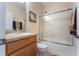 Bathroom with a large glass enclosed tub and shower, toilet, and vanity sink with modern fixtures at 14157 Oasis Cove Blvd # 104, Windermere, FL 34786