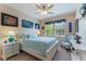 Bright bedroom with a white frame bed, lots of decor, and sunlit windows at 14157 Oasis Cove Blvd # 104, Windermere, FL 34786