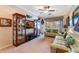 A cozy living room featuring plush sofas, a large window, and display cabinets at 14157 Oasis Cove Blvd # 104, Windermere, FL 34786