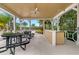 Outdoor kitchen area with picnic tables and lush views, creating a welcoming space for community gatherings at 14157 Oasis Cove Blvd # 104, Windermere, FL 34786