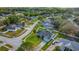 Aerial view of a property with a large yard and a community with tree-lined streets at 14736 Pine Cone Trl, Clermont, FL 34711