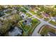 An aerial view showcases a private backyard with green grass and mature landscaping at 14736 Pine Cone Trl, Clermont, FL 34711