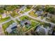 An aerial view displays a home with a screened in pool, fenced yard, and mature landscaping at 14736 Pine Cone Trl, Clermont, FL 34711