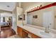 Well-designed bathroom with a double vanity, modern lighting, and hardwood floors at 14736 Pine Cone Trl, Clermont, FL 34711