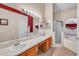 Well-lit bathroom featuring double sinks, soaking tub, and separate shower in a modern design at 14736 Pine Cone Trl, Clermont, FL 34711