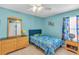 Charming ' bedroom with bright blue walls, playful decor, and ample natural light at 14736 Pine Cone Trl, Clermont, FL 34711