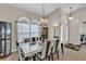 Elegant dining room featuring a modern table set, chandelier, and large windows for plenty of light at 14736 Pine Cone Trl, Clermont, FL 34711