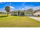 Charming single-story home with a well-manicured lawn and inviting curb appeal at 14736 Pine Cone Trl, Clermont, FL 34711