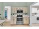 Functional kitchen layout with stainless oven and microwave, plus a laundry room view at 14736 Pine Cone Trl, Clermont, FL 34711