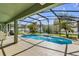 A private screened in pool with a fountain is surrounded by a landscaped backyard at 14736 Pine Cone Trl, Clermont, FL 34711