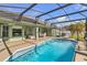 A large screened in private pool with a covered patio is perfect for outdoor entertaining at 14736 Pine Cone Trl, Clermont, FL 34711