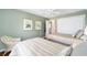 Bedroom with two beds, neutral green walls, and closet storage at 1537 Eastover Ter, The Villages, FL 32162