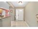 Bright foyer featuring neutral tiling, high ceilings, and a glimpse into the living spaces at 1537 Eastover Ter, The Villages, FL 32162