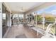 Inviting sunroom with multiple seating options and large windows for natural light and outdoor views at 1537 Eastover Ter, The Villages, FL 32162