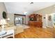 Inviting living room with hardwood floors, built-in shelving, and sliding doors to the patio at 1537 Eastover Ter, The Villages, FL 32162